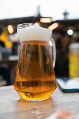Cool beer full pitcher on wood table