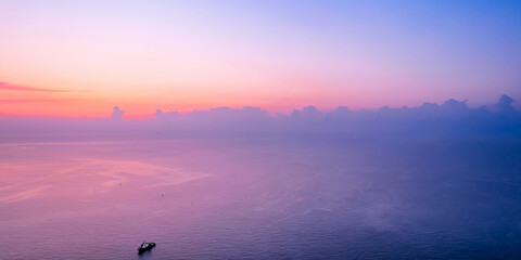 A small sailing boat in the early morning sea of Qingdao, Shandong, China