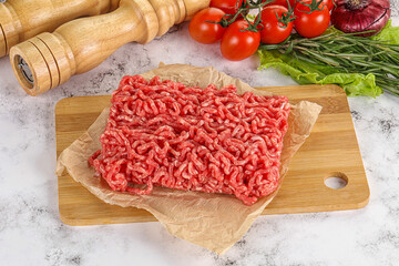 Raw minced beef meat on cutting board
