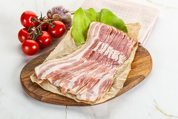 Sliced pork bacon oved board