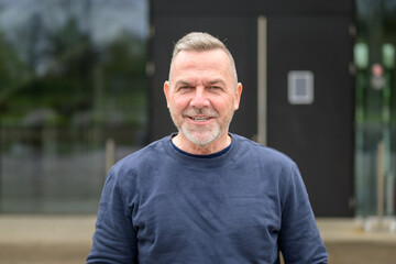 Portrait of a middle aged man looking friendly to camera