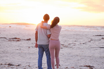 Sunset, sky and couple on beach with hug, romance and travel holiday together for outdoor...