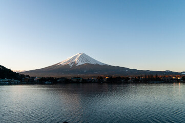 Mount Fuji on a bright winter morning, as seen from across lake Kawaguchi, and the nearby town of Kawaguchiko.
