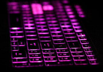  laptop keyboard and purple lights close up