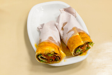 Lavash doner kebab ( zurna et tavuk doner durum )  or shawarma sliced in plate isolated. 