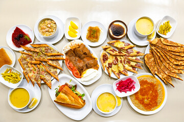 Turkish and Arabic Traditional Ramadan doner kebab with tasty tomato sauce and rice or turkish pilav in white plate on wood table background. ( Pilav ustu doner). Ekmek arasi doner, doner durum. 