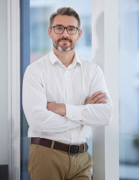 Business man, arms crossed and portrait in the morning with job, smile and confidence at creative company. Manager, office and creative director at a journalism agency with a mature leader and proud