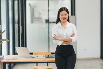 Attractive charming asian woman arms crossed self-confident person worker friendly smile good mood at modern office.