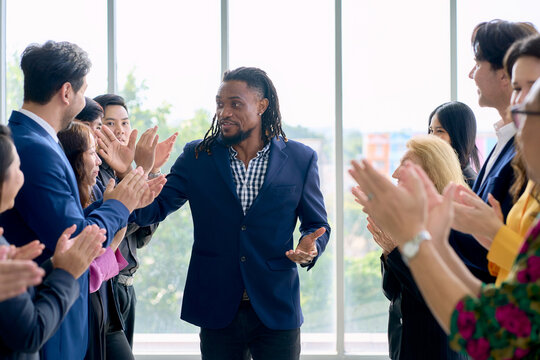 African American Businessman walking in line up and crap hand to celebrate for success in seminar business session.