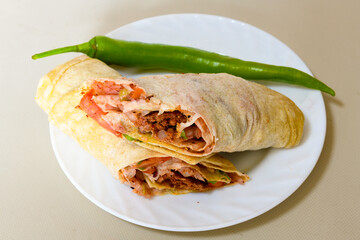 Lavash doner kebab ( zurna et tavuk doner durum )  or shawarma sliced in plate isolated. 