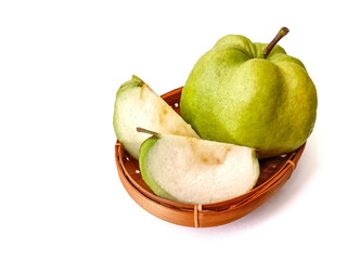 Whole and sliced ​​green guava in bamboo container. Isolated on white background