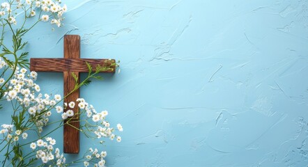 wooden cross with white flowers on blue background, in the style of copy space concept for easter celebration and religious vacation stock photo; flat lay banner design with text area, empty place