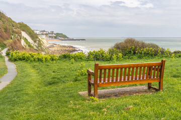 Naklejka na ściany i meble A bench near Castle Cove overlooking Ventnor Bay, Isle of Wight, UK