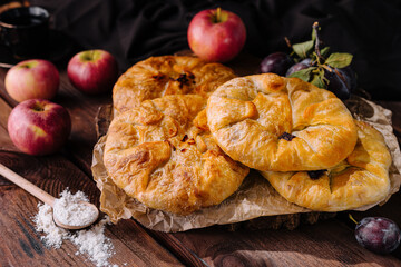 Rustic homemade apple pies on wooden table