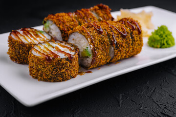 Crunchy spicy sushi roll on elegant plate