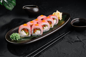 Gourmet sushi rolls on elegant black plate