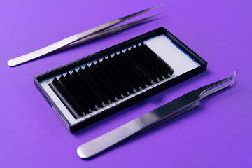 Professional eyelash extension tools on purple background