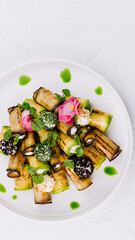 Gourmet grilled eggplant dish with herbs and sauce