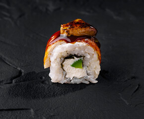 Gourmet eel sushi roll on slate background