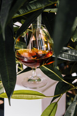 Cognac glass amidst green foliage