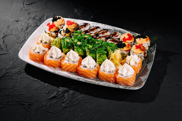 Assorted sushi platter on dark background