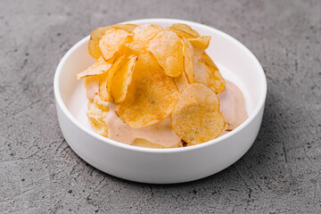 Bowl of crispy golden potato chips