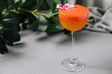 Elegant cocktail with flower garnish