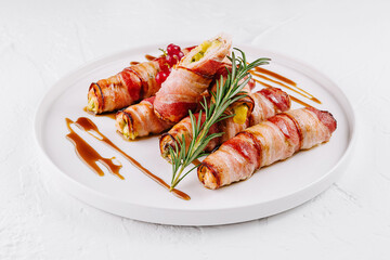 Bacon-wrapped stuffed jalapenos on plate