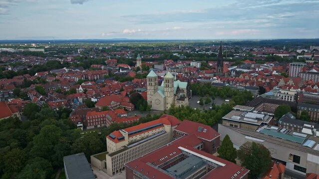 An aerial drone shot of St. Paulus Dom, also known as M&uuml;nster Cathedral, on Domplatz in M&uuml;nster on a sunny day. It is a central and culturally significant area of central M&uuml;nster, Germany. 