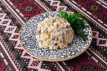 Traditional olivier salad on ornate plate