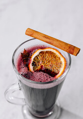Mulled wine in glass with citrus and cinnamon