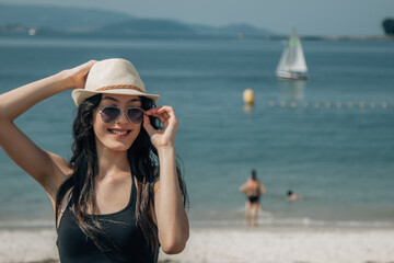 portrait of tourist with hat and sunglasses on the beach