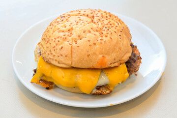 Big tasty burger with beef cutlet on a plate. Hamburger, cheeseburger with mushroom. Crispy chicken burger.