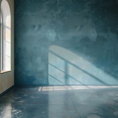Obraz premium A large, empty room with a blue wall and a window. The room is bare and empty, with no furniture or decorations. The blue wall and the window create a sense of calm and serenity