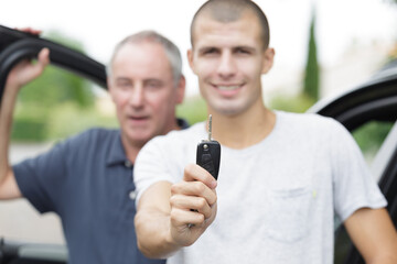 happy young man holding car keys