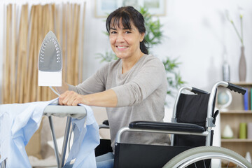 woman on wheelchair during ironing
