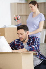 concentrated pregnant couple packing stuff