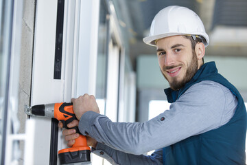 portrait of a male builder using a cordless drill