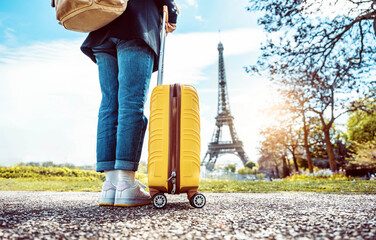 Happy tourist with luggage visiting Eiffel Tower in Paris, France - Travel and vacation life style concept