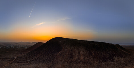 Beautiful aerial sunset image over Volcan Calderon Hondo volcanic crater silhouetted against the...