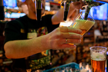 A lively bartender pouring a golden beer at a vibrant bar, capturing the appealing atmosphere and the freshness of the beverage