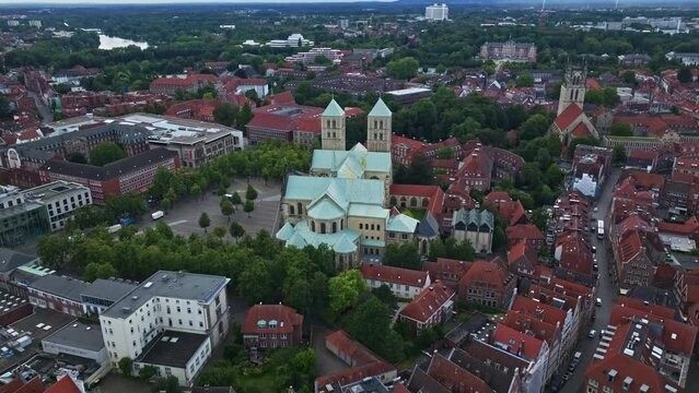 An aerial drone shot of St. Paulus Dom, also known as M&uuml;nster Cathedral, on Domplatz in M&uuml;nster on a sunny day. It is a central and culturally significant area of central M&uuml;nster, Germany. 