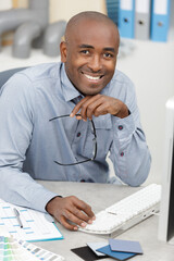 handsome executive smiling in the office