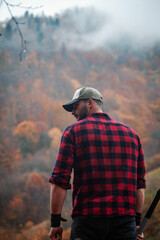 Handsome Serious Strong Young Man in Plaid Shirt and Cap - 789964420