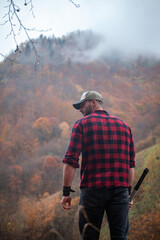 Handsome Serious Strong Young Man in Plaid Shirt and Cap - 789965089