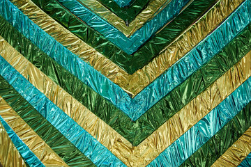 Texture or background of different green and yellow stripes of crumpled foil