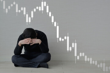 株価の暴落に悩む男性
