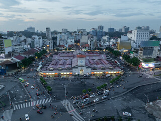 Aerial drone skyline video of Saigon cityscape at sunset in District 1, with Ben Thanh market