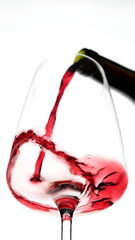 Pouring red wine in glass, white background