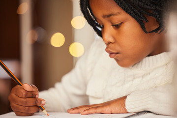 African child, drawing and home with notebook, growth and development of kid, artist and learning of art. Creative, education and girl in house, table and pencil with color, talent and youth on desk